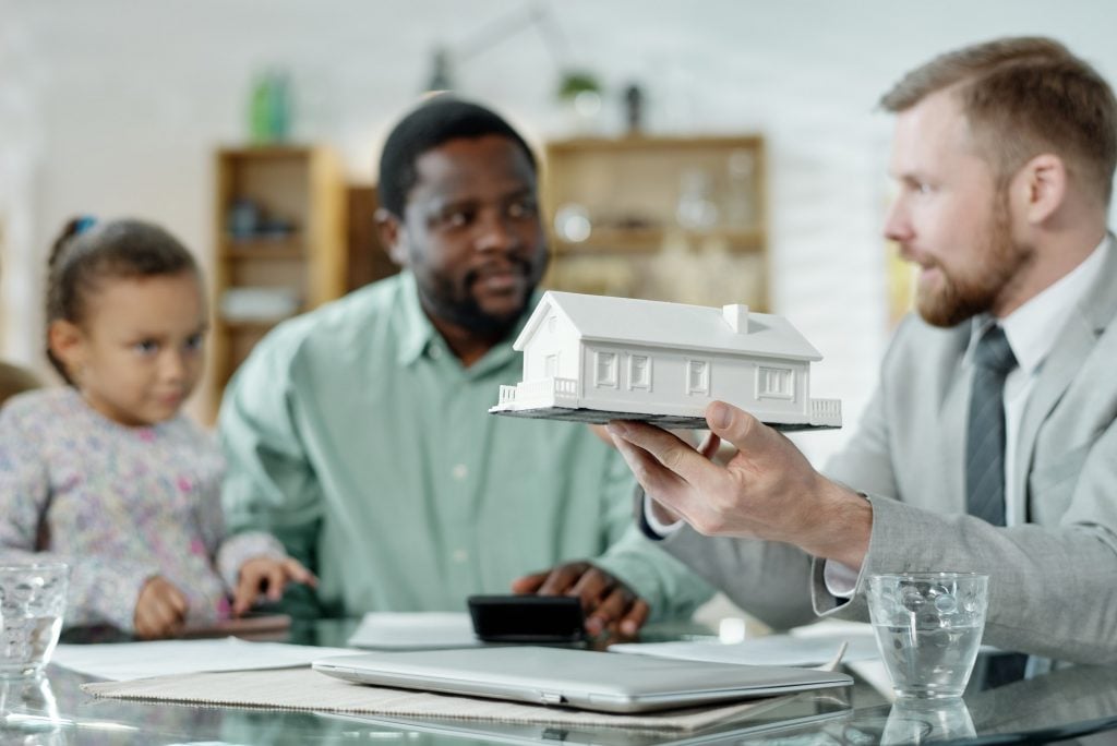 Financial accountant with mockup house giving consultation