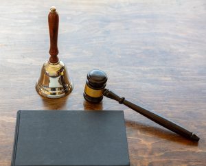 Judge auction gavel and bell on wooden background, copy space.