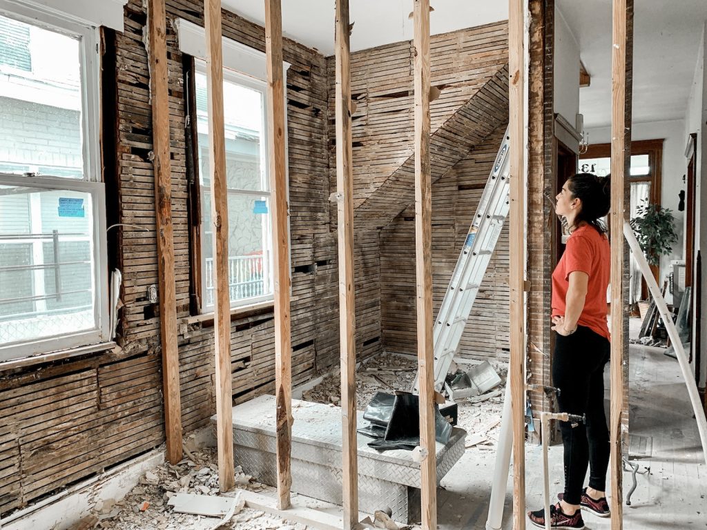 Woman standing in room with unfinished walls